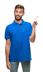 Young handsome man over isolated background with a big smile on face, pointing with hand and finger to the side looking at the camera.