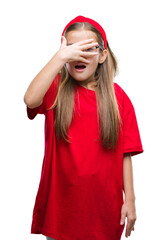 Young beautiful girl wearing glasses over isolated background peeking in shock covering face and eyes with hand, looking through fingers with embarrassed expression.