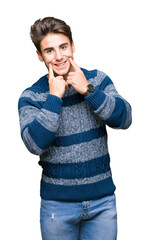 Young handsome man over isolated background Smiling with open mouth, fingers pointing and forcing cheerful smile