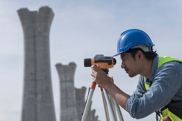 surveyor at work. construction worker using level camera. Surveyor with  looking throughout digital...