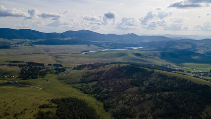 Naklejka premium Aerial panorama of meadows, mountain and lakes. Nature landscape scene. Zlatibor , Serbia.