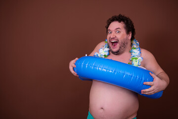 Dreams about the weekend. Funny fat man enjoys his vacation at the sea. Brown background.