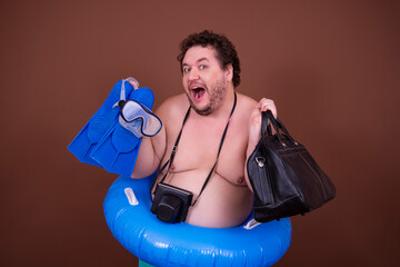 Dreams about the weekend. Funny fat man enjoys his vacation at the sea. Brown background.