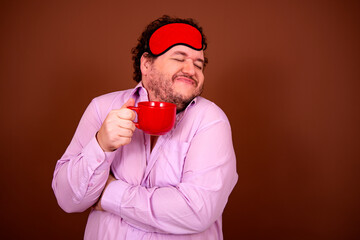 Early morning fresh gossip. Funny fat man drinking coffee. Brown background.