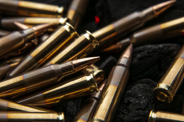 Cartridges for automatic carbine caliber .223 on charcoal. Ammunition for automatic and semi-automatic rifles. Dark back