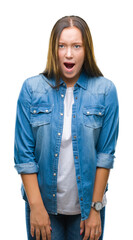 Fototapeta premium Young caucasian beautiful woman over isolated background afraid and shocked with surprise expression, fear and excited face.