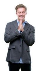 Young handsome blond business man begging and praying with hands together with hope expression on face very emotional and worried. Asking for forgiveness. Religion concept.