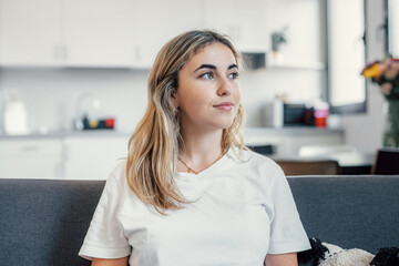 Head shot close up dreamy young smiling beautiful woman looking away, visualizing future indoors of recollecting good memories. Happy healthy millennial girl enjoying free weekend time at home.. © Daniel