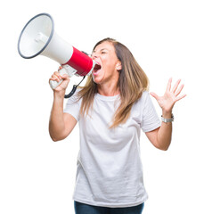 Middle age hispanic woman yelling through megaphone over isolated background annoyed and frustrated shouting with anger, crazy and yelling with raised hand, anger concept