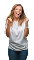 Middle age senior hispanic woman over isolated background very happy and excited doing winner gesture with arms raised, smiling and screaming for success. Celebration concept.
