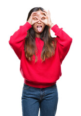 Young asian woman wearing winter sweater over isolated background doing ok gesture like binoculars sticking tongue out, eyes looking through fingers. Crazy expression.