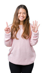 Young beautiful brunette woman wearing pink winter sweater over isolated background showing and pointing up with fingers number six while smiling confident and happy.