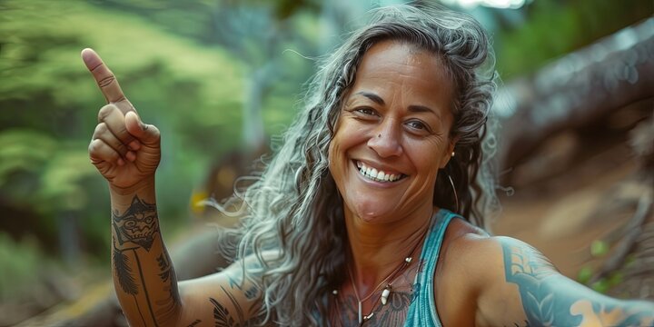 Smiling 42 year old Hawaiian female pointing in the air