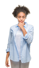 Young afro american woman over isolated background looking confident at the camera with smile with crossed arms and hand raised on chin. Thinking positive.