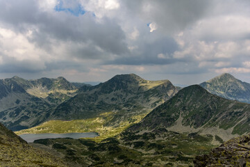 Bucura lake nestled among rolling hills in Retezat National Park, Romania