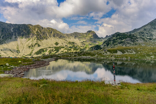 Bucura lake nestled among rolling hills in Retezat National Park, Romania