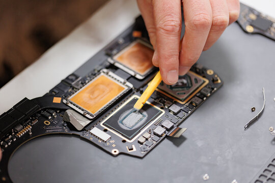RUSSIA - March 23, 2024: Repair Macbook pro Apple, maintenance and replacement of thermal paste, broken screen and replace used rechargeable batteries for recycling