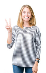 Beautiful young woman wearing stripes sweater over isolated background showing and pointing up with fingers number two while smiling confident and happy.