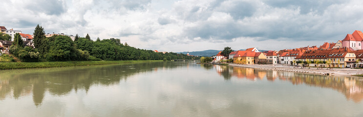 A panorama cityscape of the city Maribor and the river Drava outdoor with nature and buildings