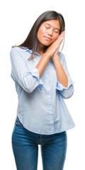 Young asian business woman over isolated background sleeping tired dreaming and posing with hands together while smiling with closed eyes.