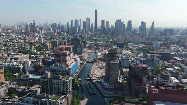 higher flying over Gowanus Canal towards downtown Brooklyn skyline