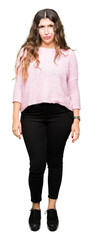 Obraz premium Young beautiful woman wearing pink sweater skeptic and nervous, frowning upset because of problem. Negative person.
