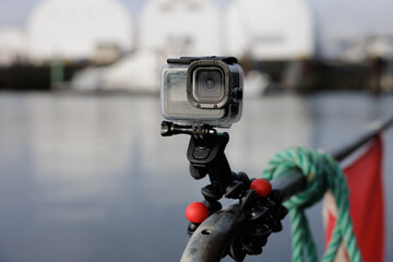 Closeup of action camera attached to a rough, rusty surface