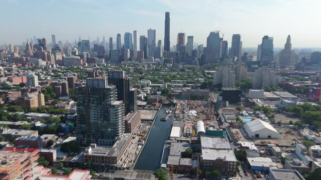 higher view of downtown Brooklyn skyline flying backward over Gowanus Canal
