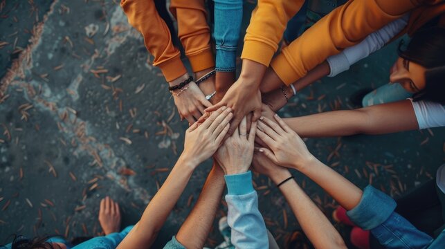 A group of diverse hands coming together in unity and support. AIG535