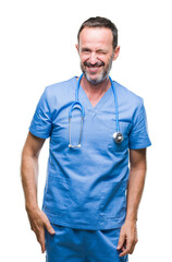 Middle age hoary senior doctor man wearing medical uniform over isolated background winking looking at the camera with sexy expression, cheerful and happy face.