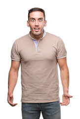 Fototapeta premium Handsome young man scared in shock with a surprise face, afraid and excited with fear expression