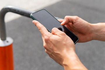 Unrecognizable person using smartphone during outdoor workout in Poblenou