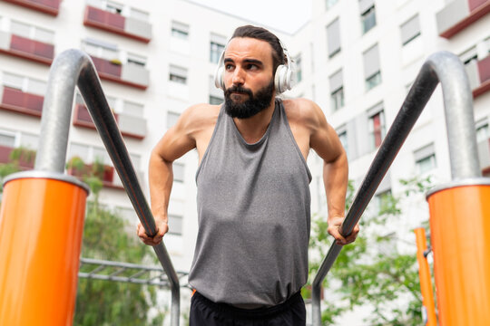 Man exercising at outdoor gym in urban setting