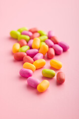 Colorful hard mint Candies on pink background.