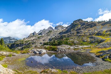 Scenic view of a mountainous landscape with a small reflective pond. Washington state