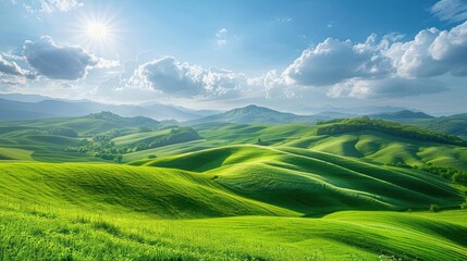 Fototapeta premium Rolling green hills bathed in sunlight on a sunny day, with a vast expanse of clear sky and scattered clouds