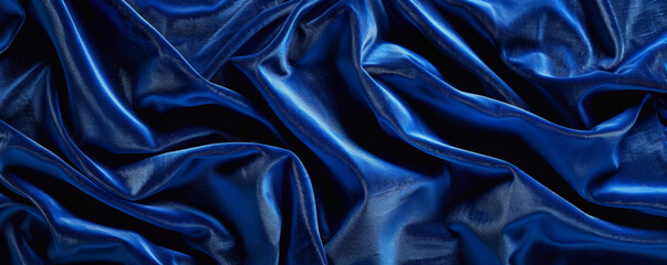 Fototapeta premium Elegant velvet background in a deep royal blue with a rich, plush texture. The luxurious fabric adds a touch of opulence and sophistication, perfect for high-end or romantic designs