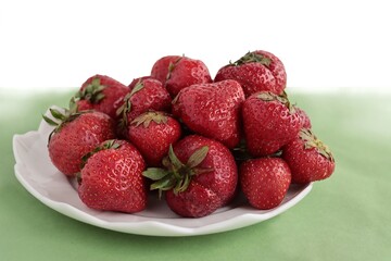 red,tasty strawberries and flowers close up