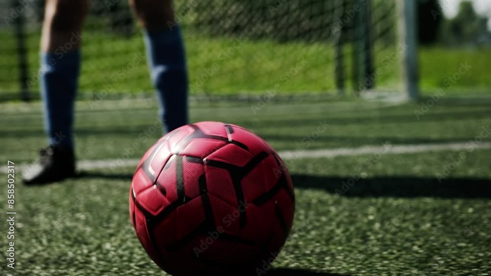 Poster Soccer Ball Moving Across Green Grass During A Soccer Game