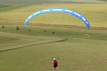  Paraglider flying from a hill