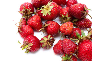 Heap of fresh ripe natural strawberries on a white saucer. Freshly picked garden strawberries. Detailed photo of strawberries on an abstract background. Close up view