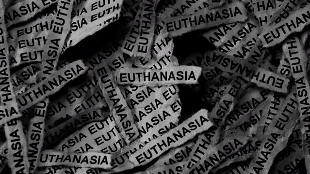 Strips of newspaper with the words Euthanasia typed on them. Black and white. Close up.