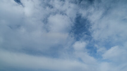 Puffy fluffy white clouds. Forming cloud moving with blue sunny, summer skies. Timelapse.