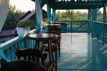 Interior of a summer cafe and brown round tables