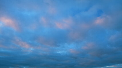Obraz premium Different shades colored clouds during sunset. Only the sky above the horizon. Timelapse.