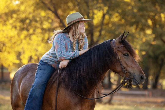 Girl cowgirl with horse