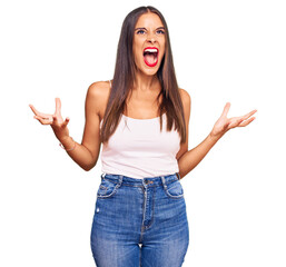 Young hispanic woman wearing casual clothes crazy and mad shouting and yelling with aggressive expression and arms raised. frustration concept.