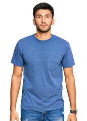Fototapeta premium Young handsome man wearing casual clothes with serious expression on face. simple and natural looking at the camera.