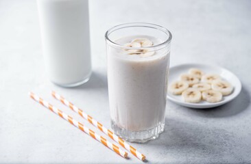 Banana milkshake with banana slices in a glass