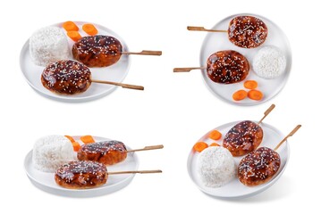 Tsukune, Japanese Chicken Meatball in teriyaki sauce with sesame seeds sprinkles with rice and vegetables in a plate on a white isolated background